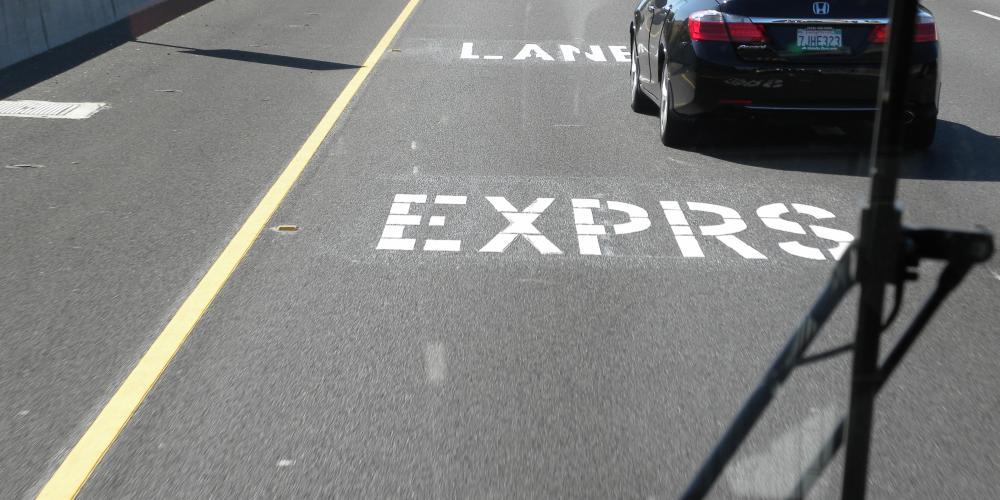 A car on a road that reads EXPRS LANE in Contra Costa County.