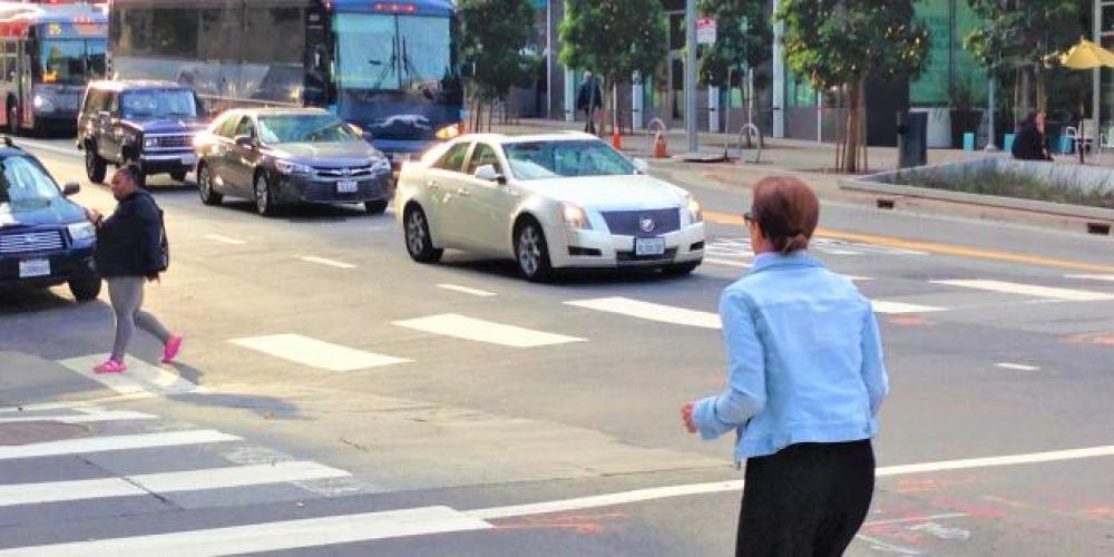 Crosswalk with pedestrians crossing. 