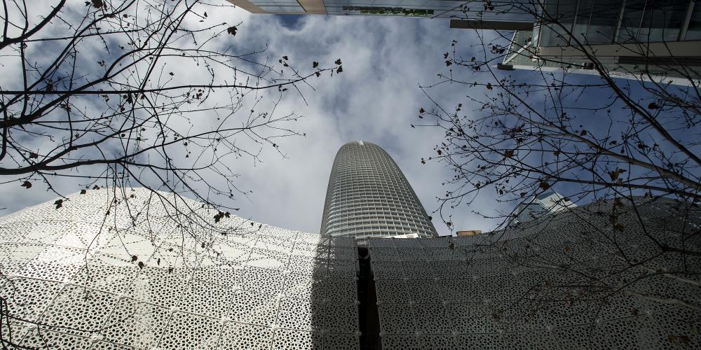 Looking up at the Salesforce Tower and the decorative exterior metal latticework of the Transbay Terminal.