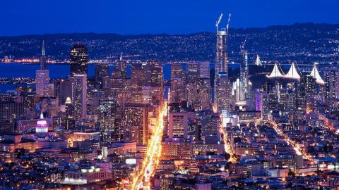San Francisco cityscape at night, including Market Street, Salesforce Tower and the Bay Lights.