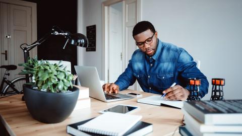 man at a desk working on computer