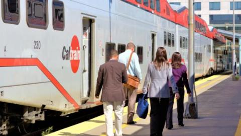 passengers walking alongside a caltrain car to load 