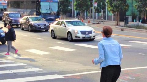 Crosswalk with pedestrians crossing. 